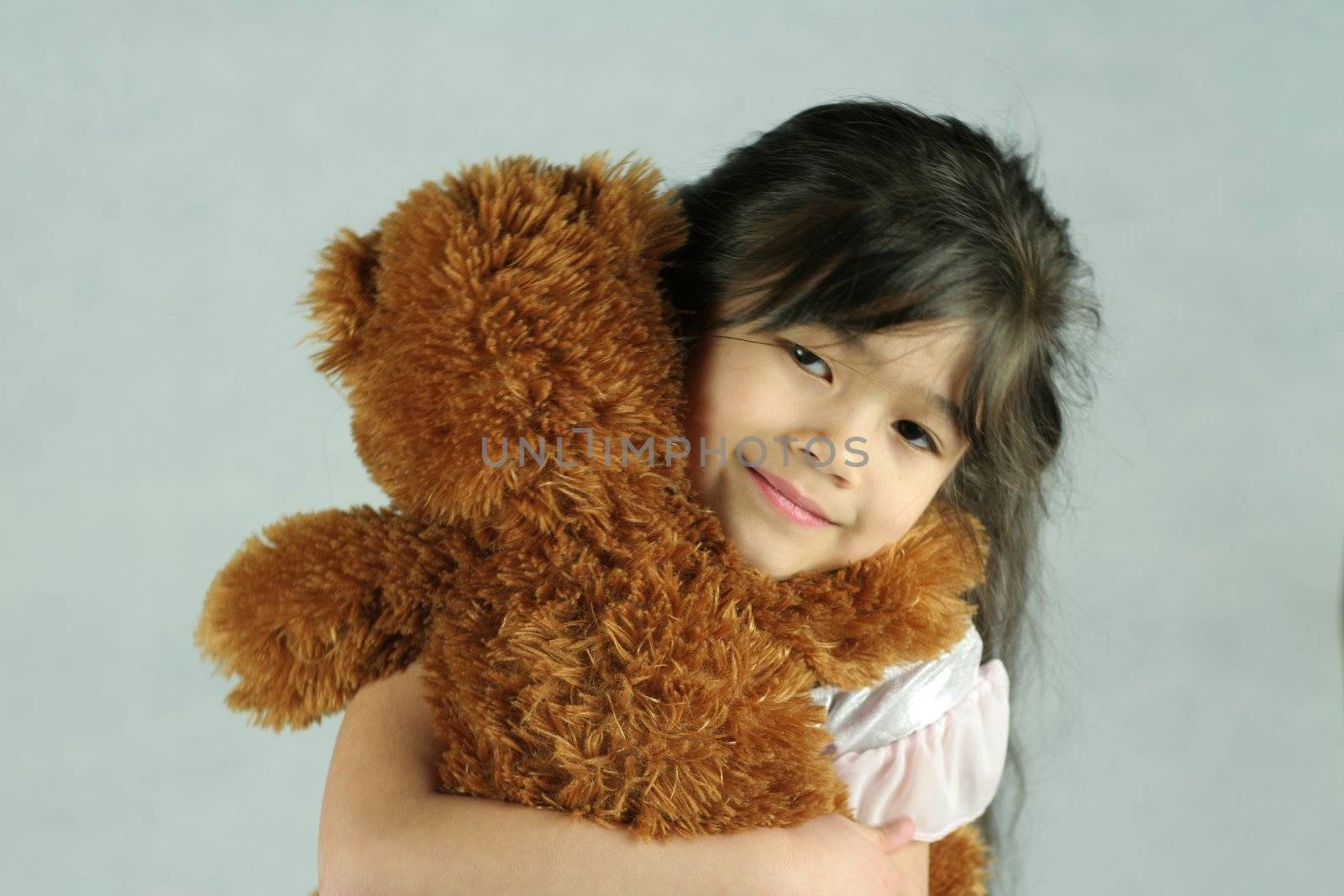 Adorable five years old girl with doll