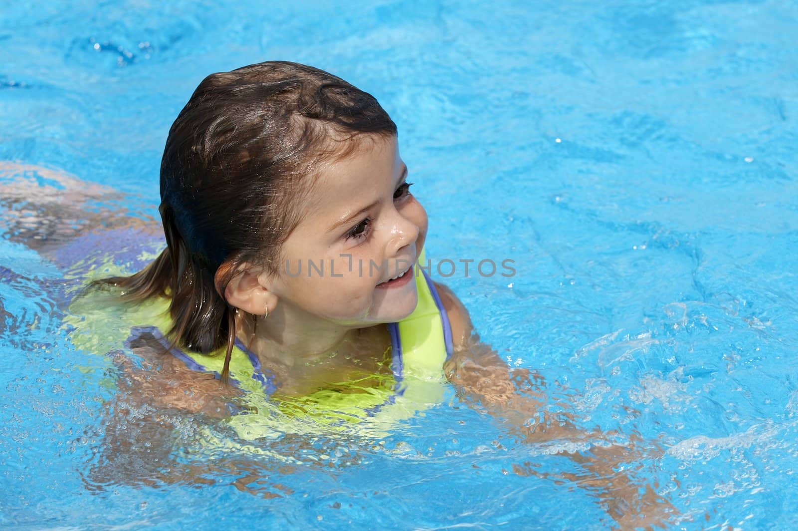 a young girl playing in pool