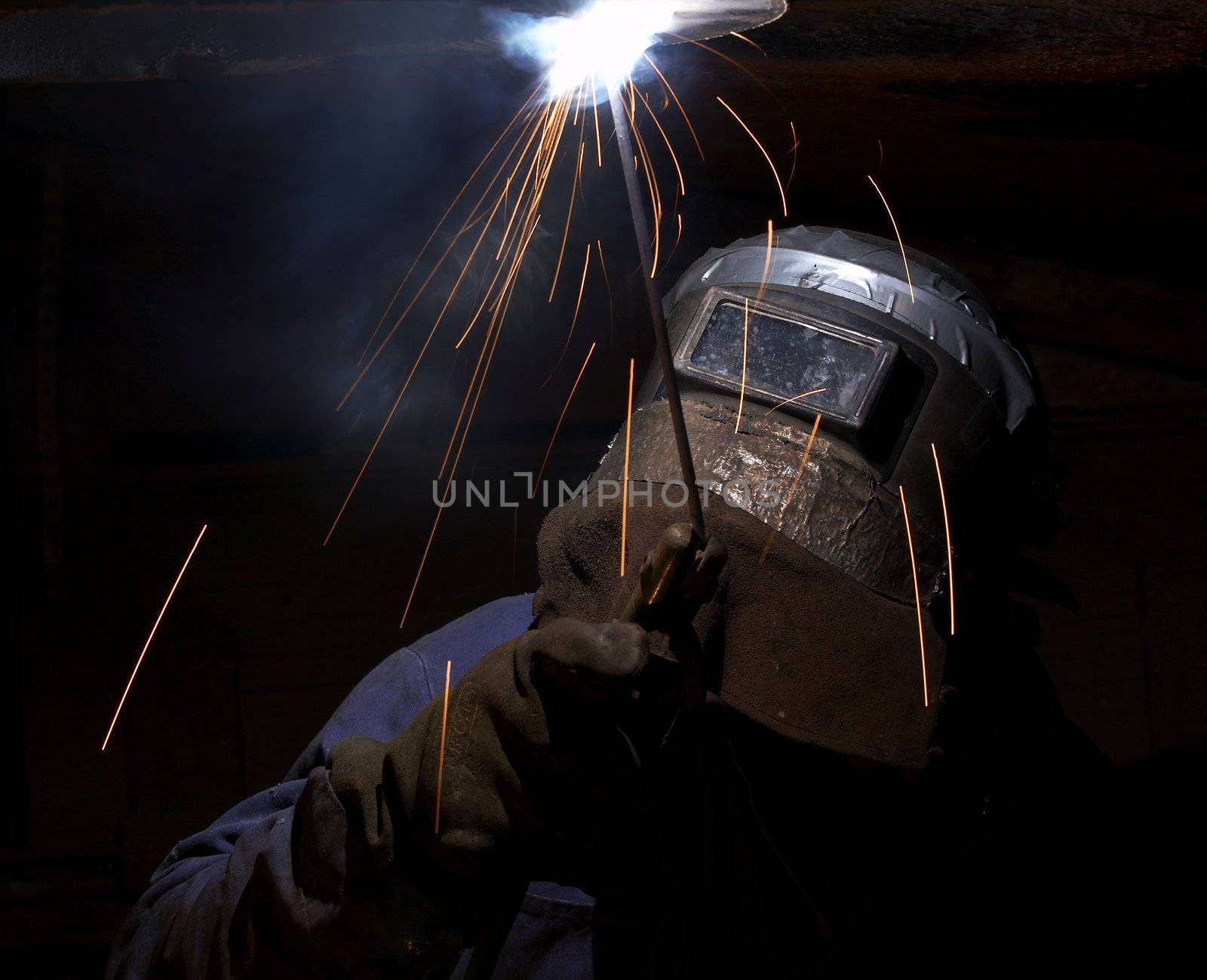 a welder working at shipyard at night