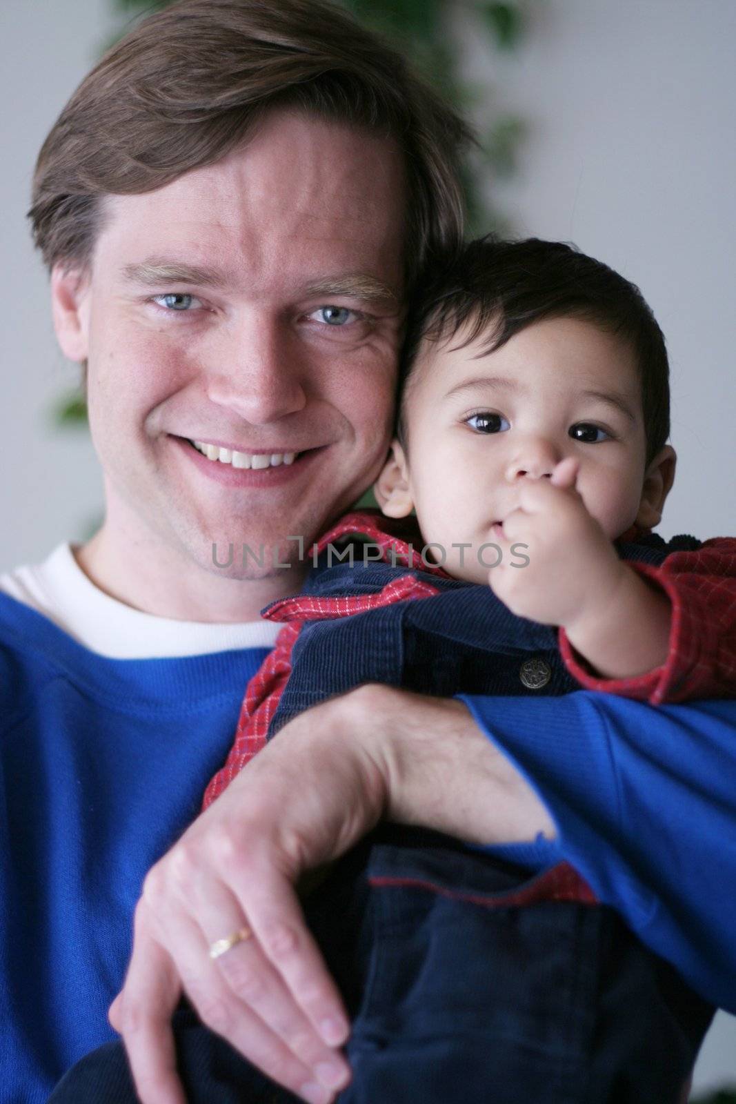 Father holding his baby boy by jarenwicklund