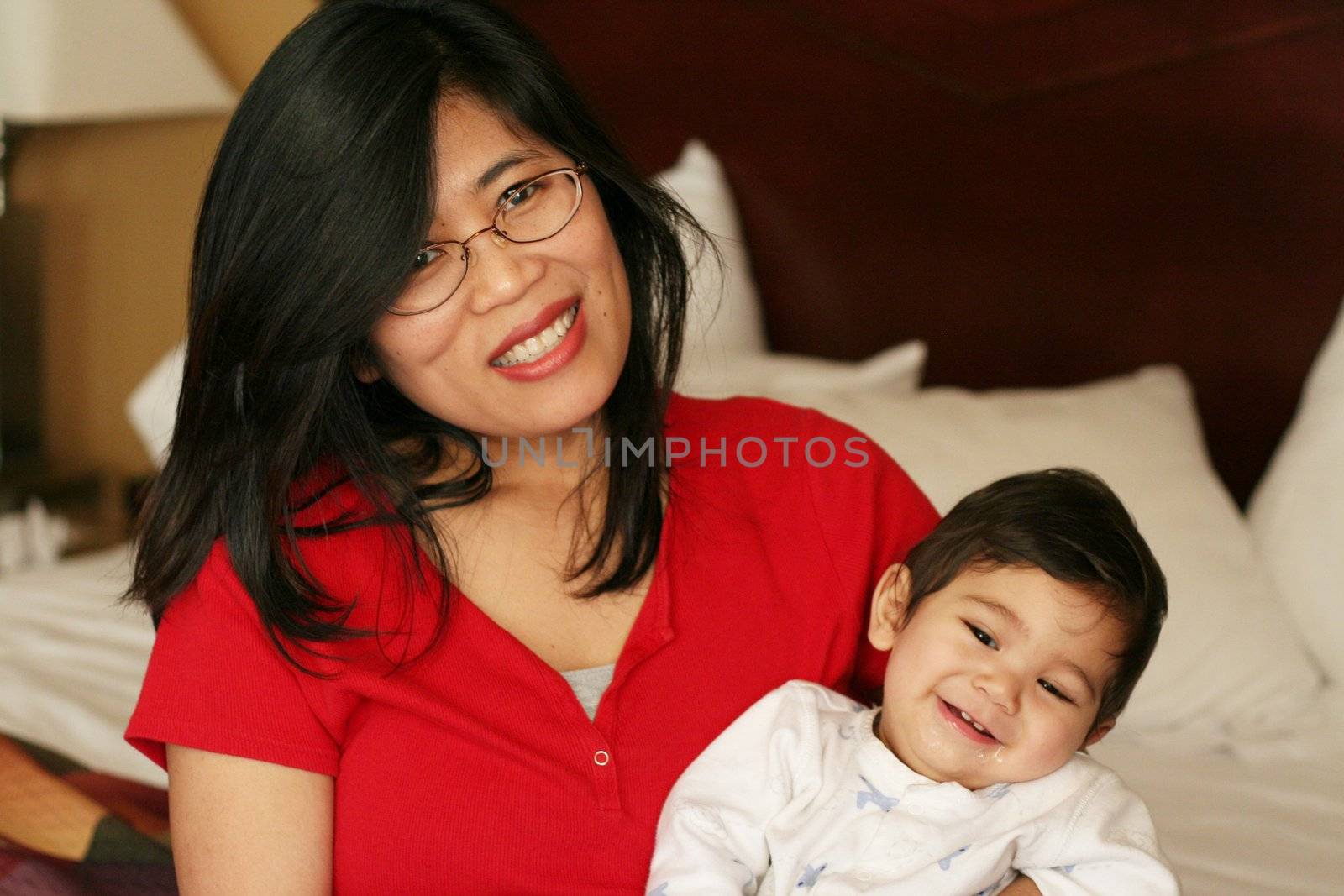 Asian mother and baby waking up with smiles