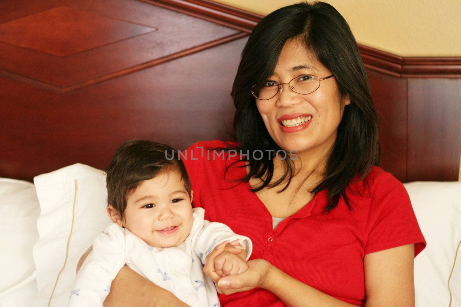 Asian mother and baby waking up with smiles