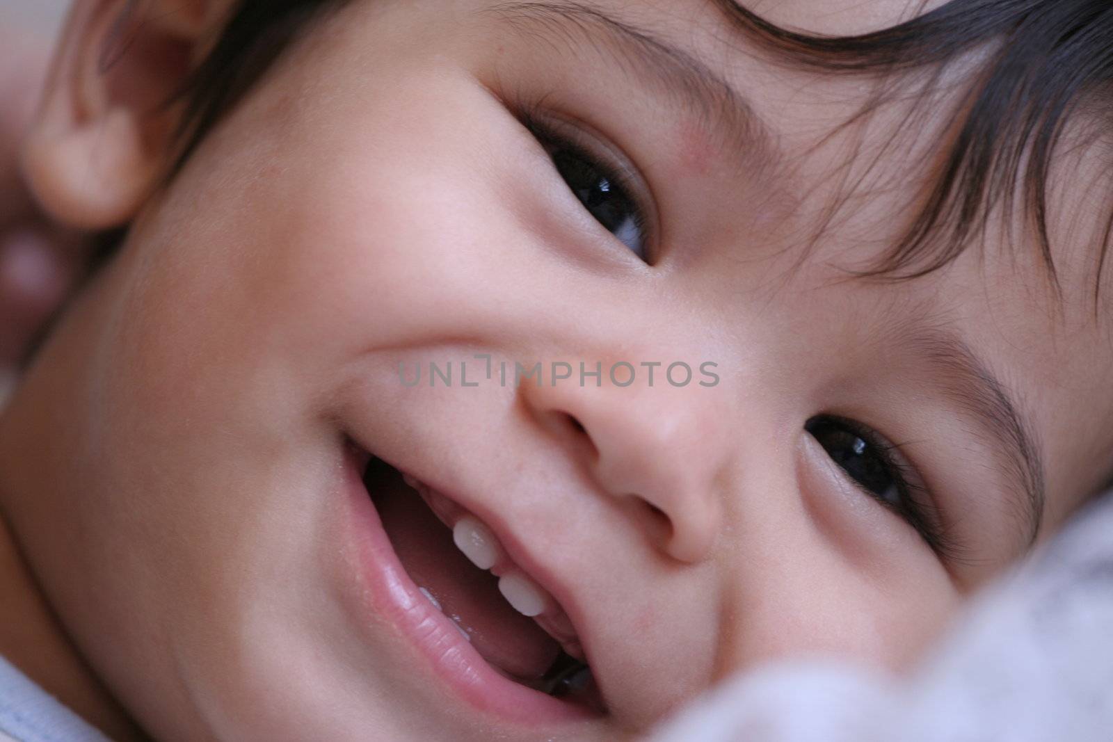 Happy baby boy smiling, part Scandinavian,Thai background