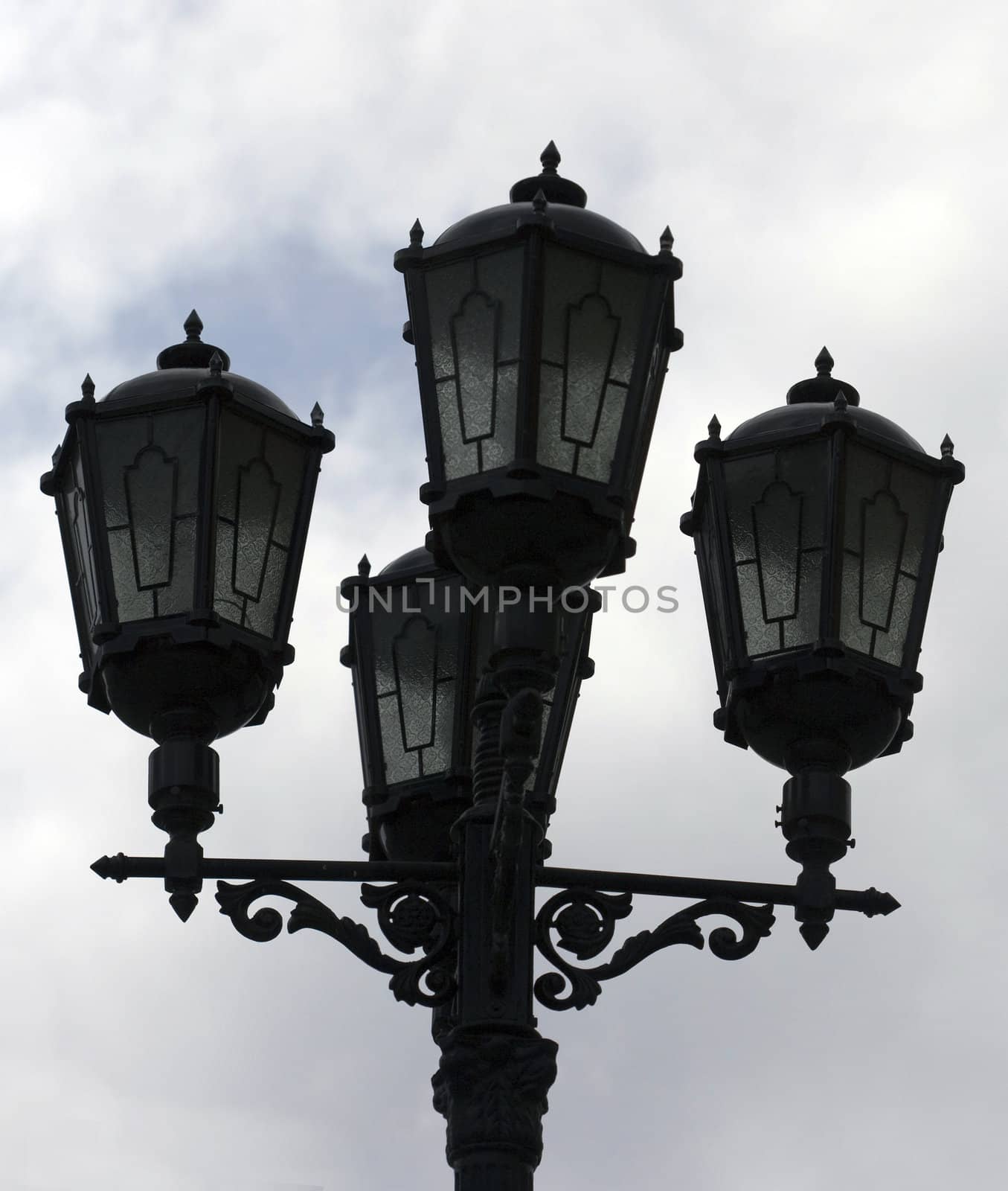 Old street-lamp on a cloudy background by Nobilior