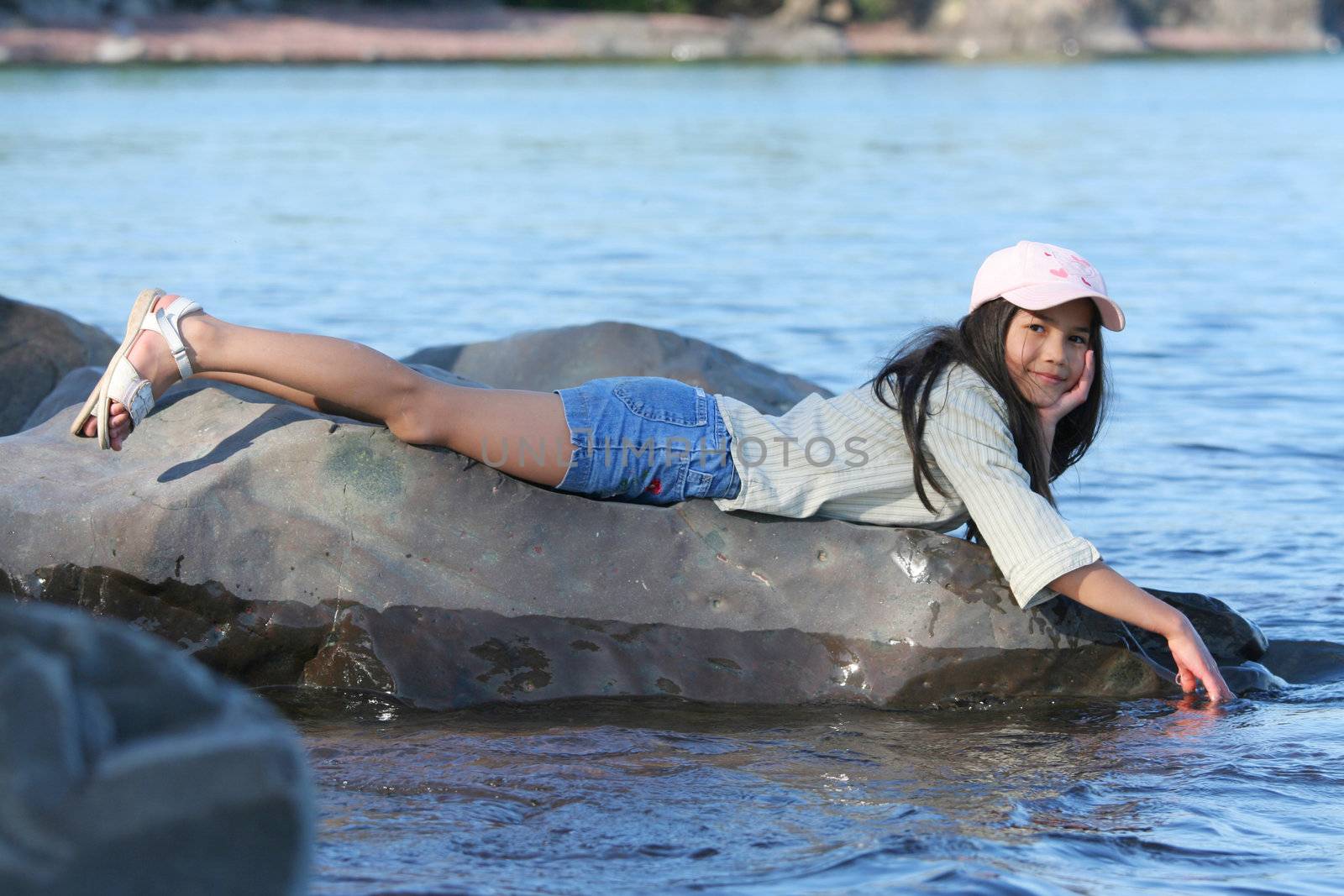 Little girl enjoying the cool lake water