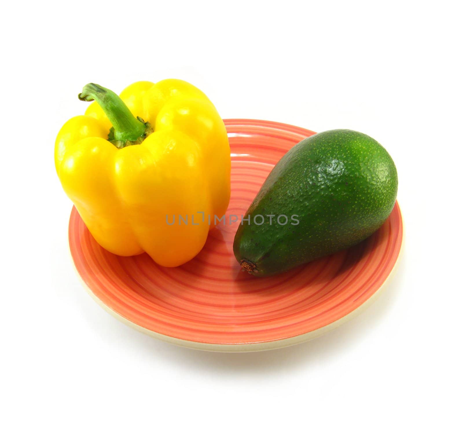 yellow pepper and avocado on a red plate