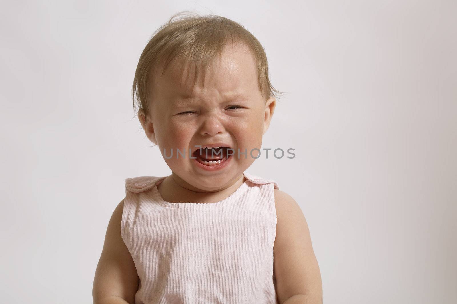 portrait of crying baby. little girl in the bad mood and to burst into tears