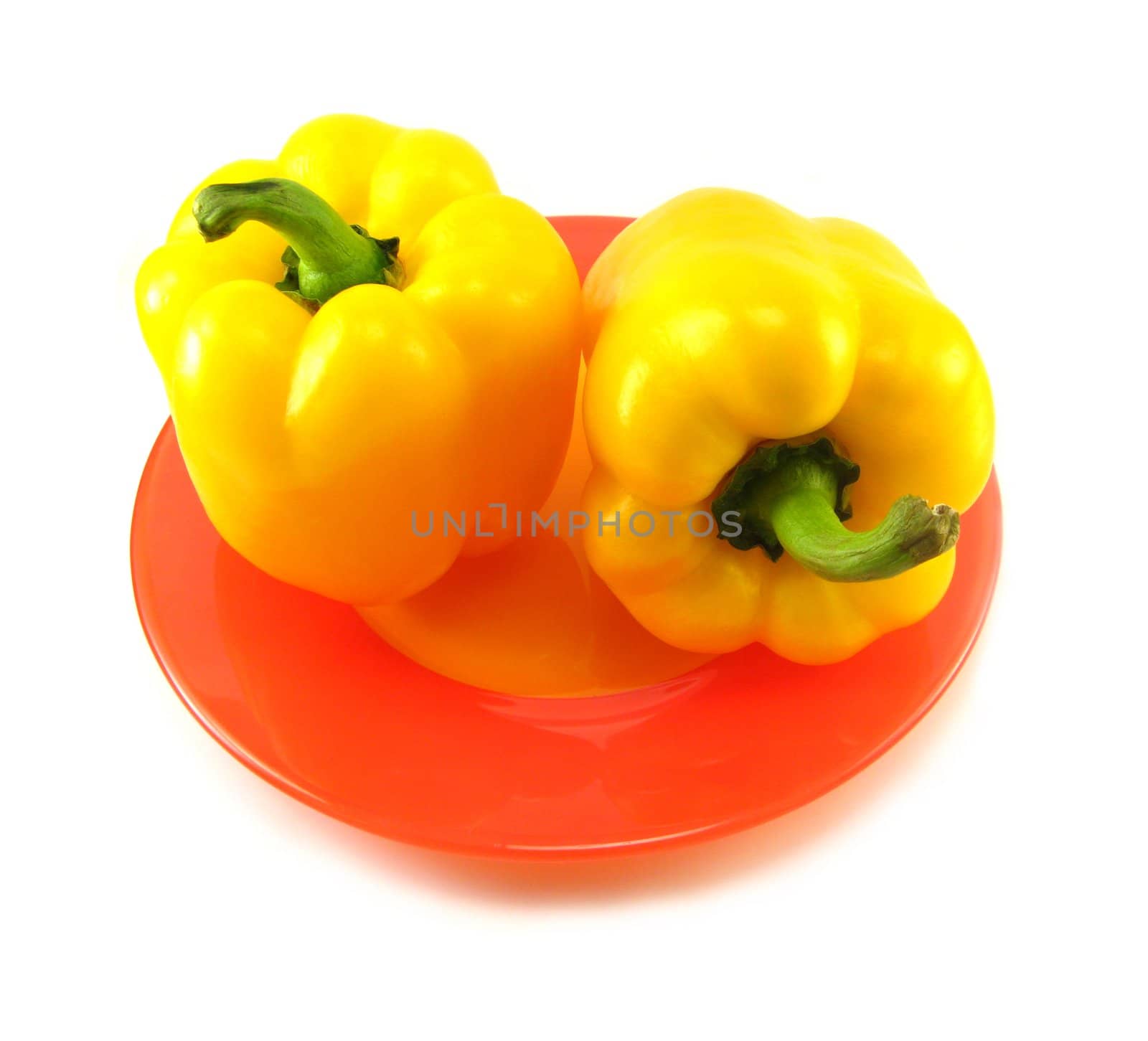 image of two yellow peppers on a red plate