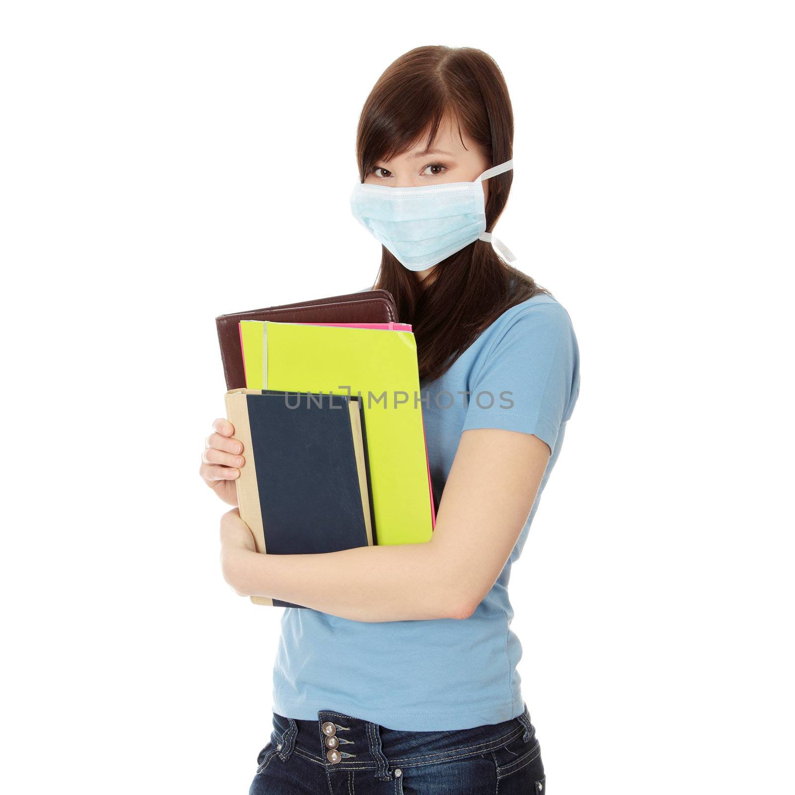 Young caucasian student woman with mask on her face. She is defending her self from viruses. Isolated on white