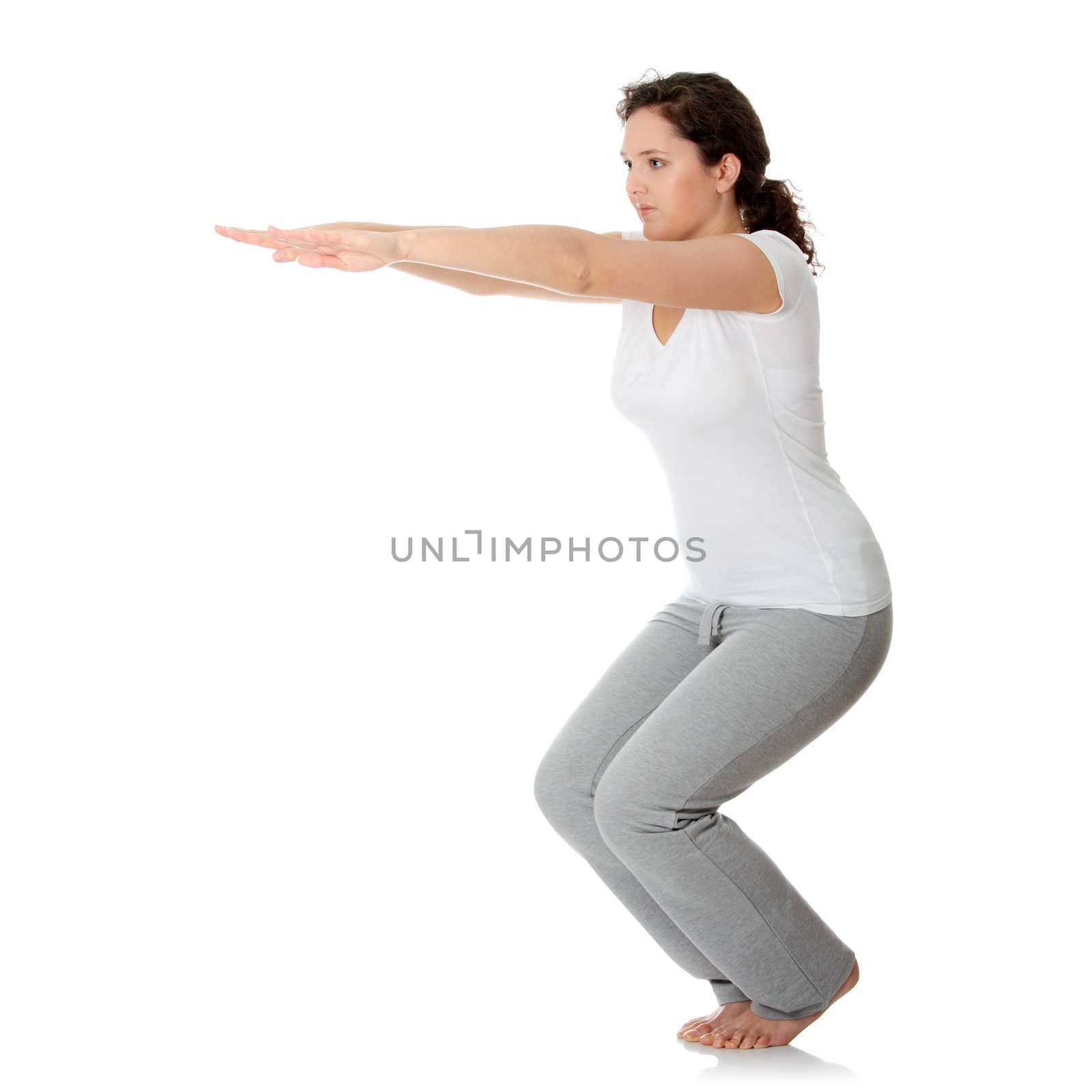 Young woman doing exercise, isolated on white