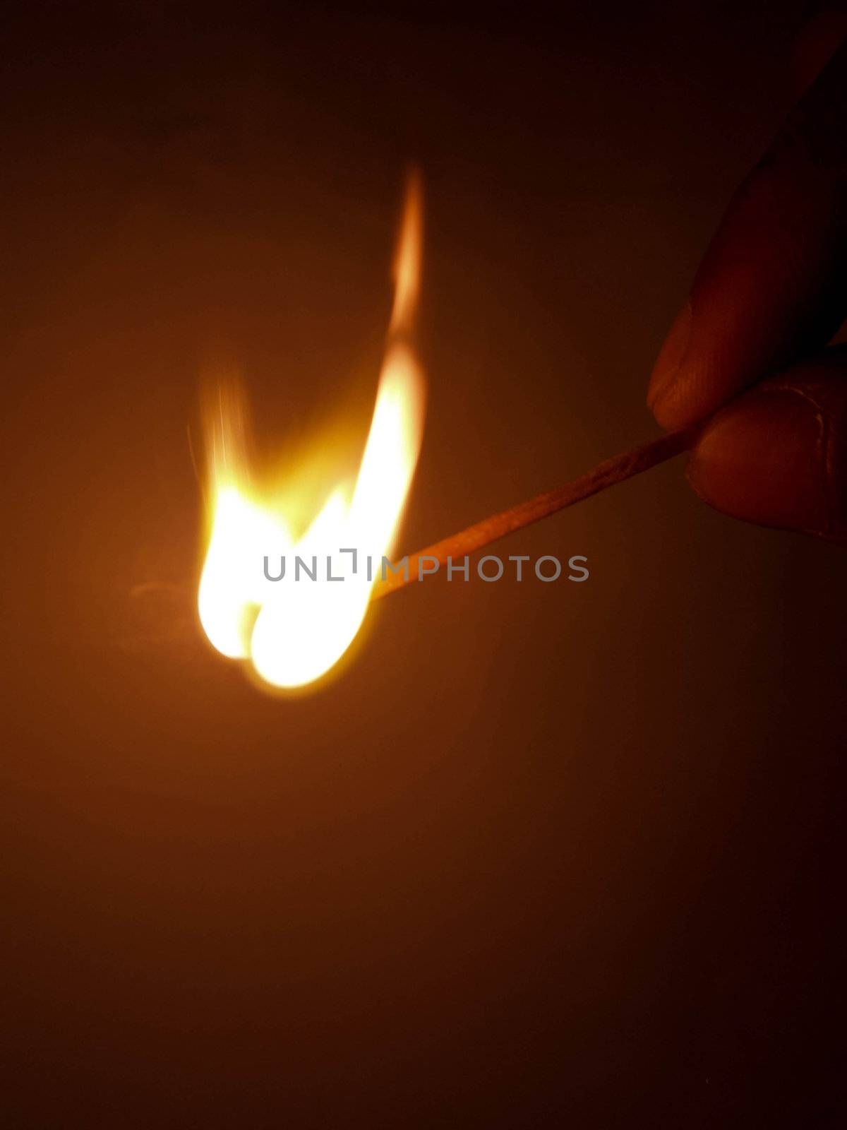 A burning matchstick just as it burst into flame.