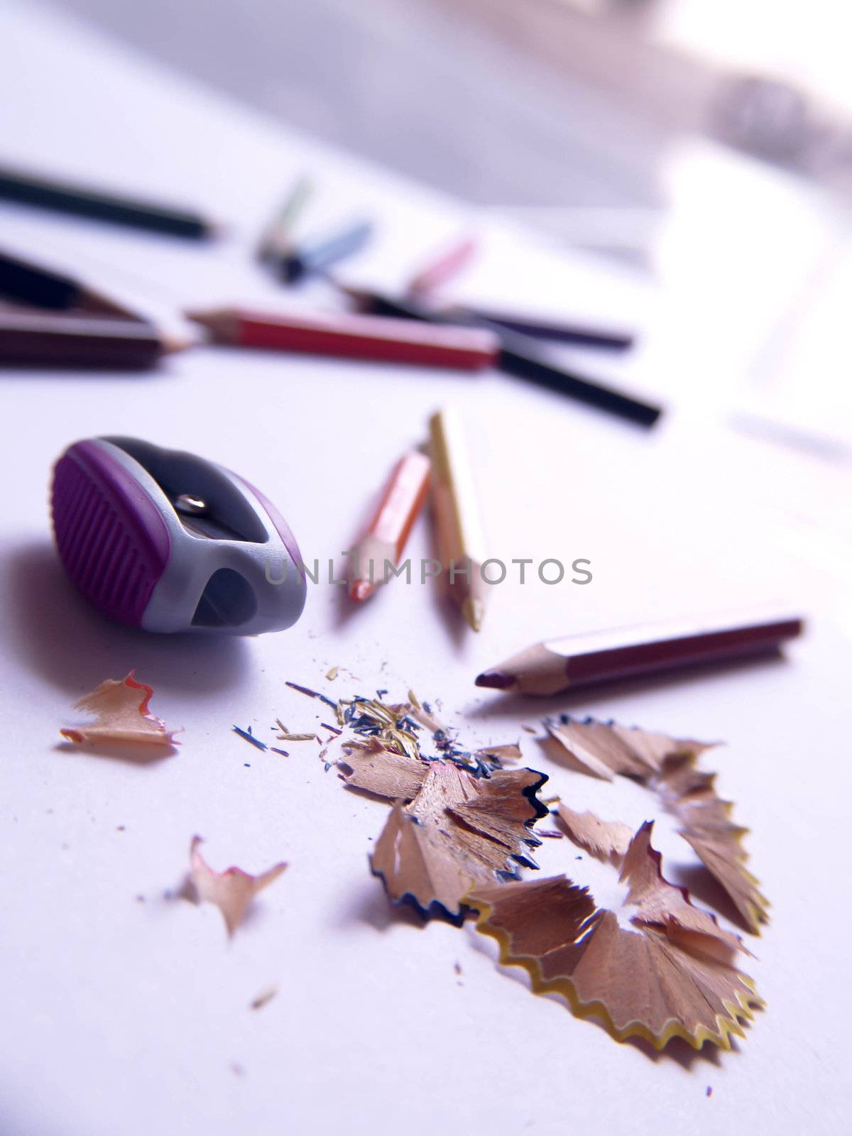 Colorful pencils shavings on a white background.