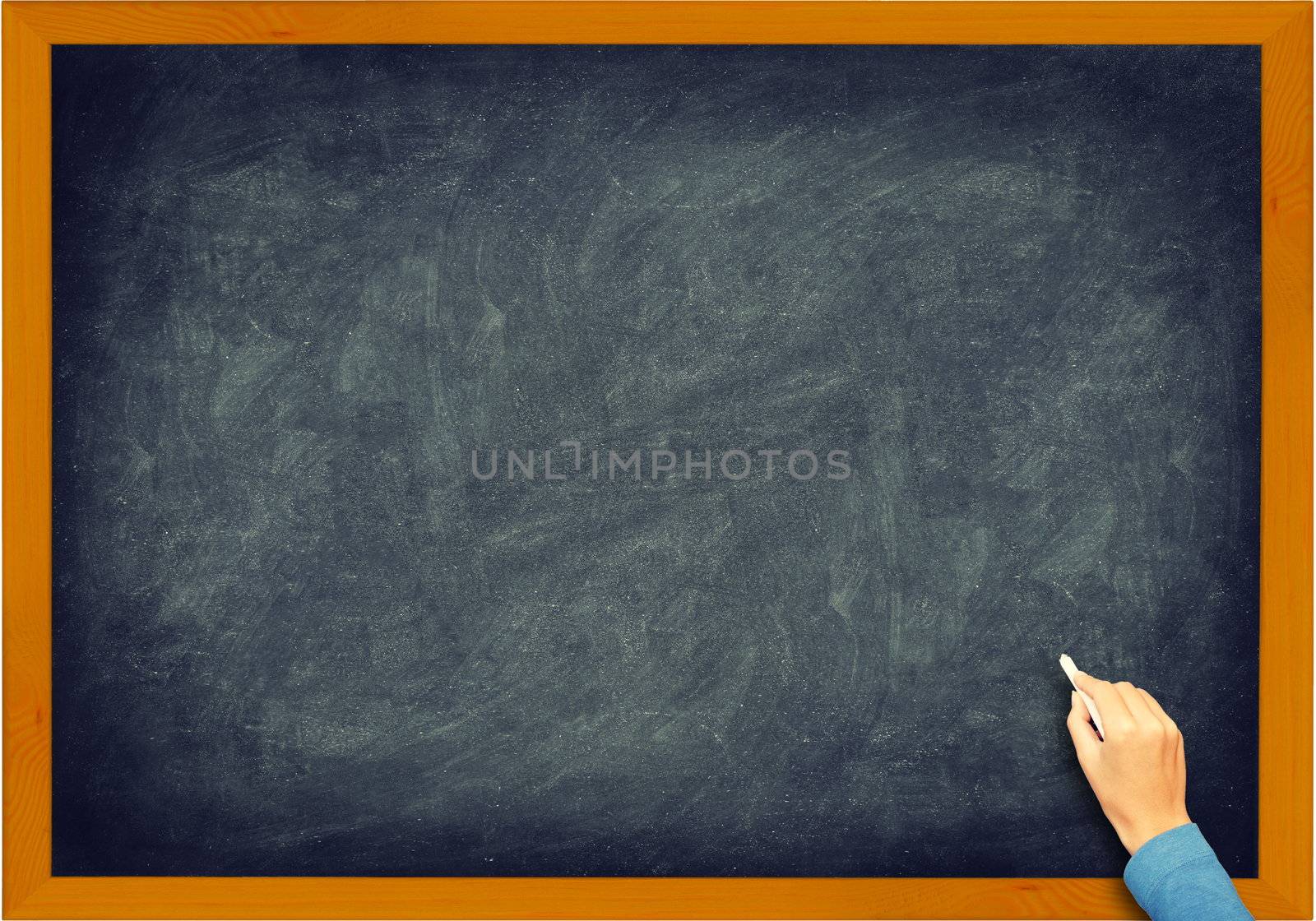 Blackboard closeup. Vintage retro chalkboard with hand, chalk and frame. Nice texture.