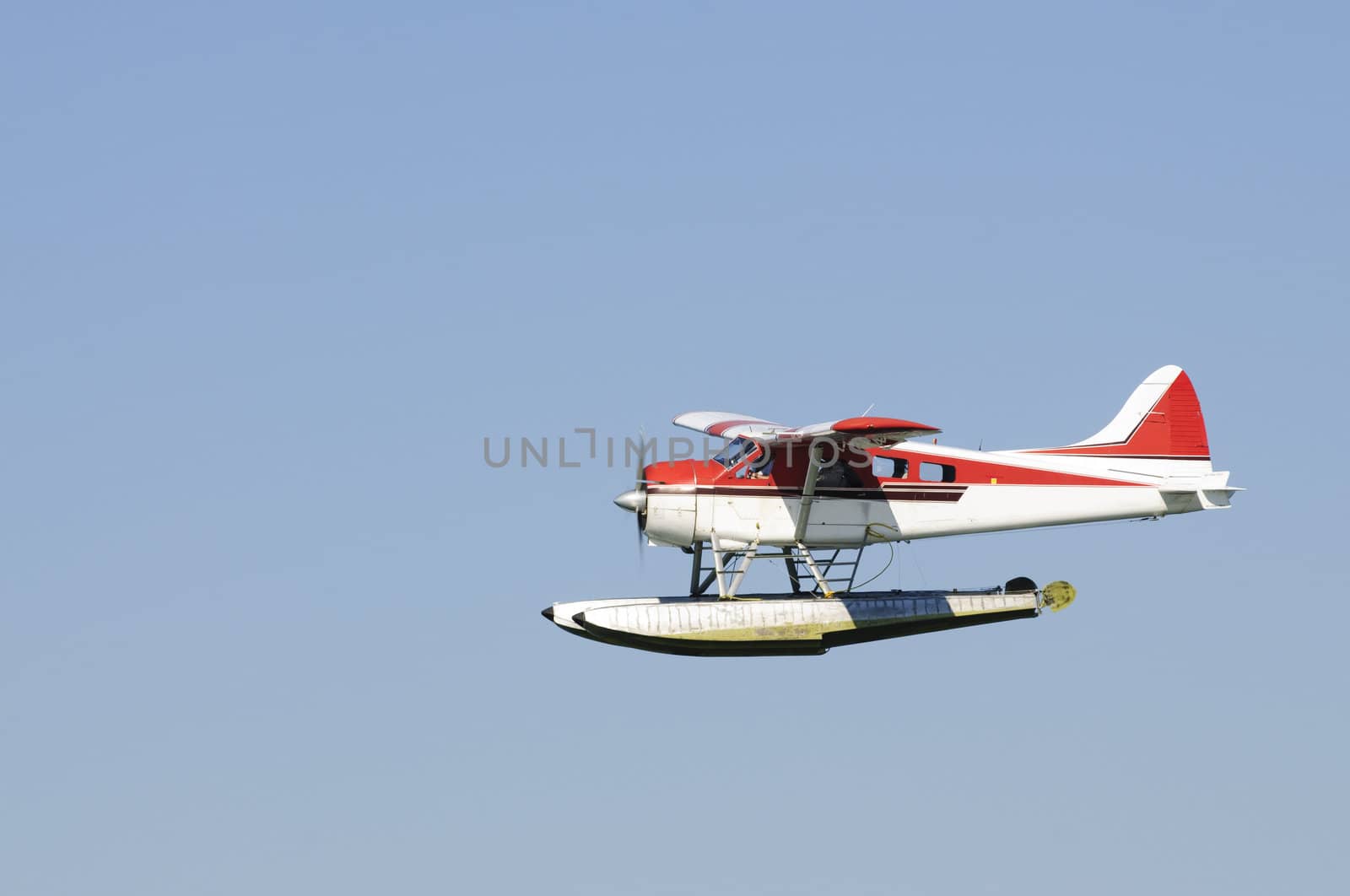 Floatplane / Seaplane flying in a blue sky in Canada