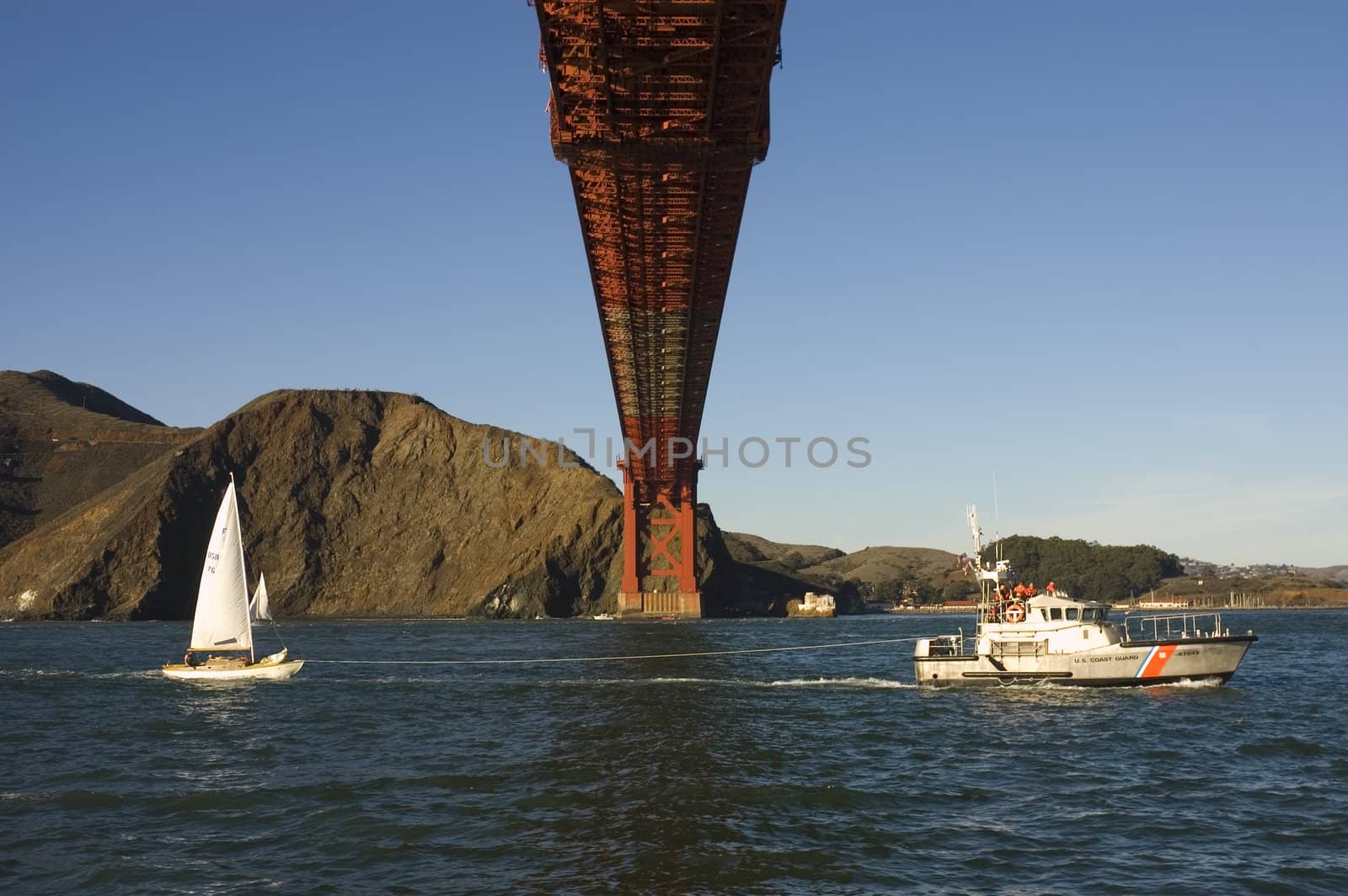 Golden gate bridge from beneath with coast guard rescue by jeffbanke