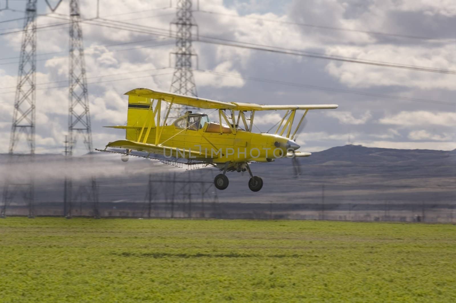 Low flying crop spraying aircraft