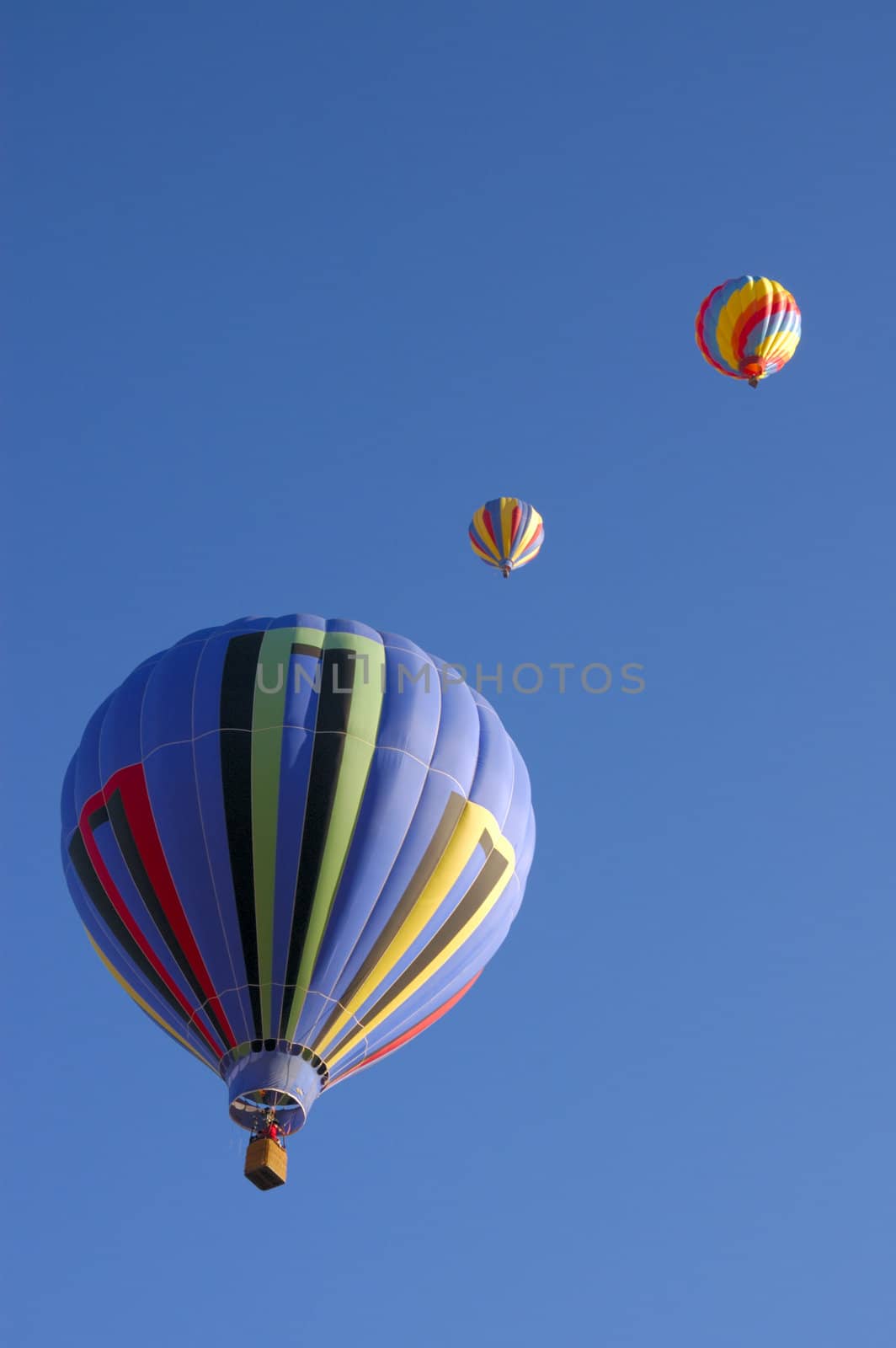 colorful balloons rising at dawn in the cold air at the Taos hot air balloon festival