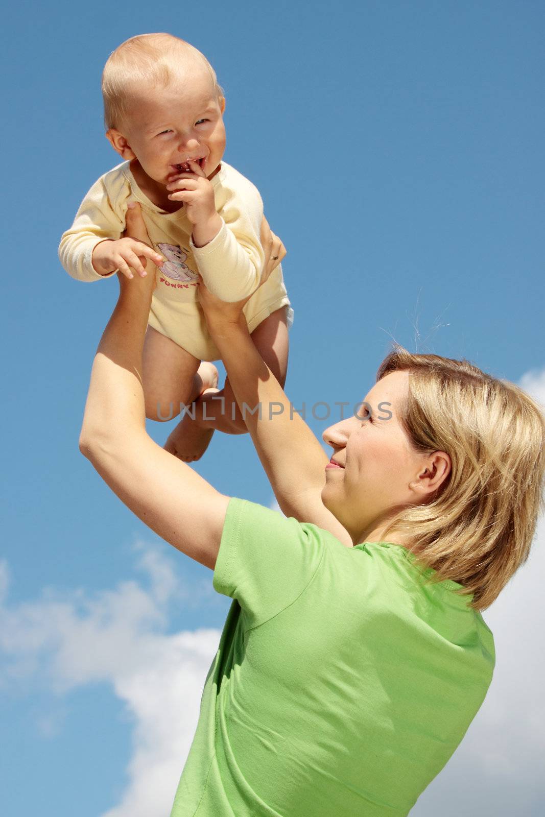 Mother with baby under blue clear sky