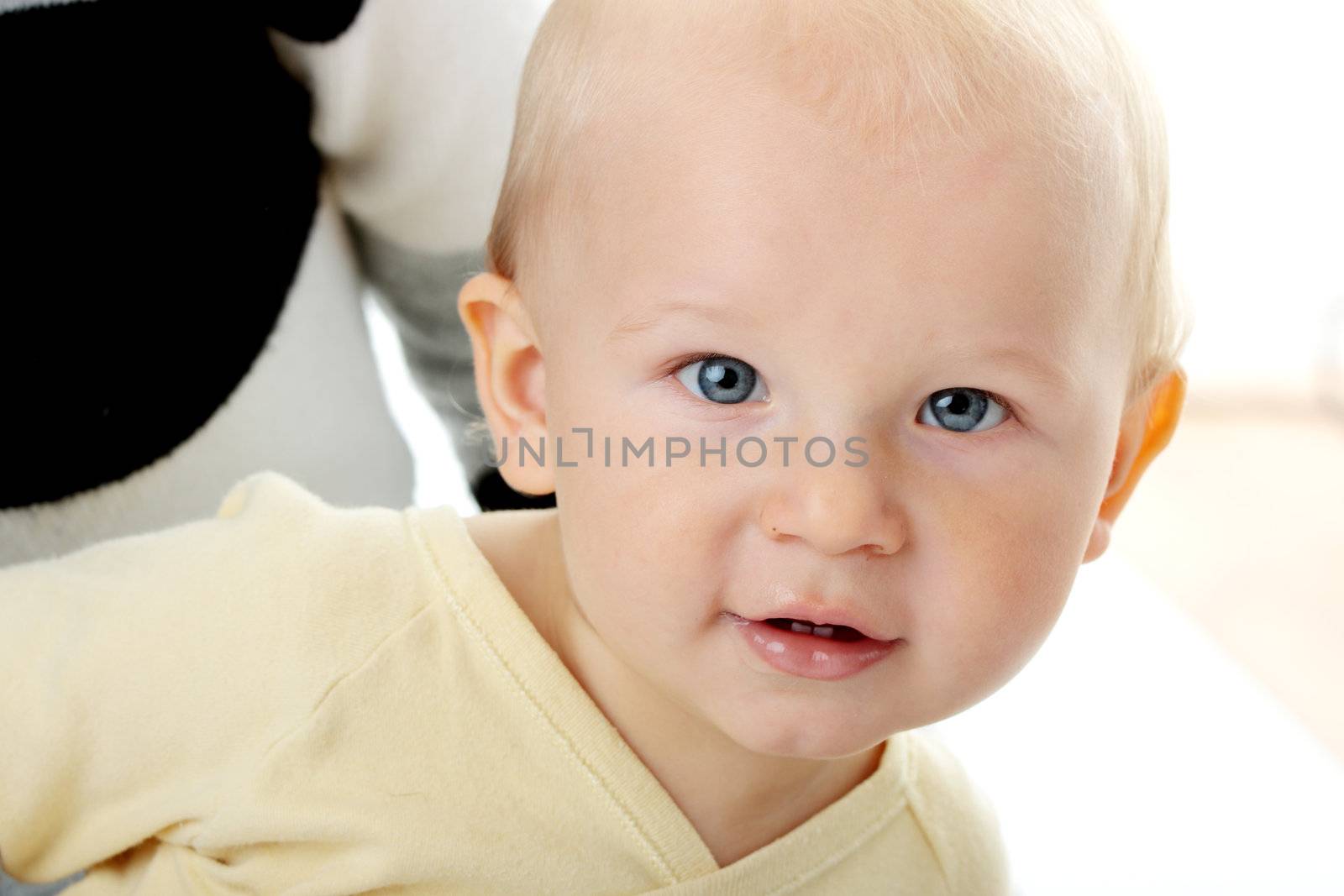 Bright closeup portrait of adorable baby boy and his mom