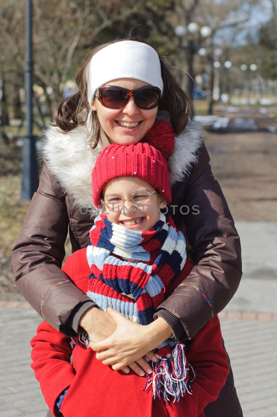 Happy mom with a daughter for a walk in the Spring Park