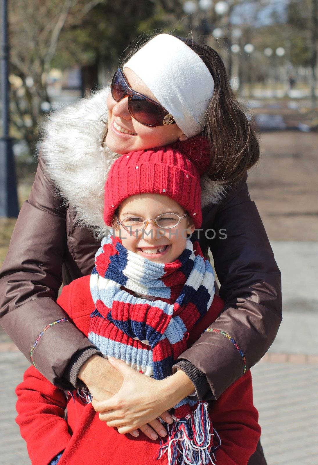 Happy mom with a daughter for a walk in the Spring Park