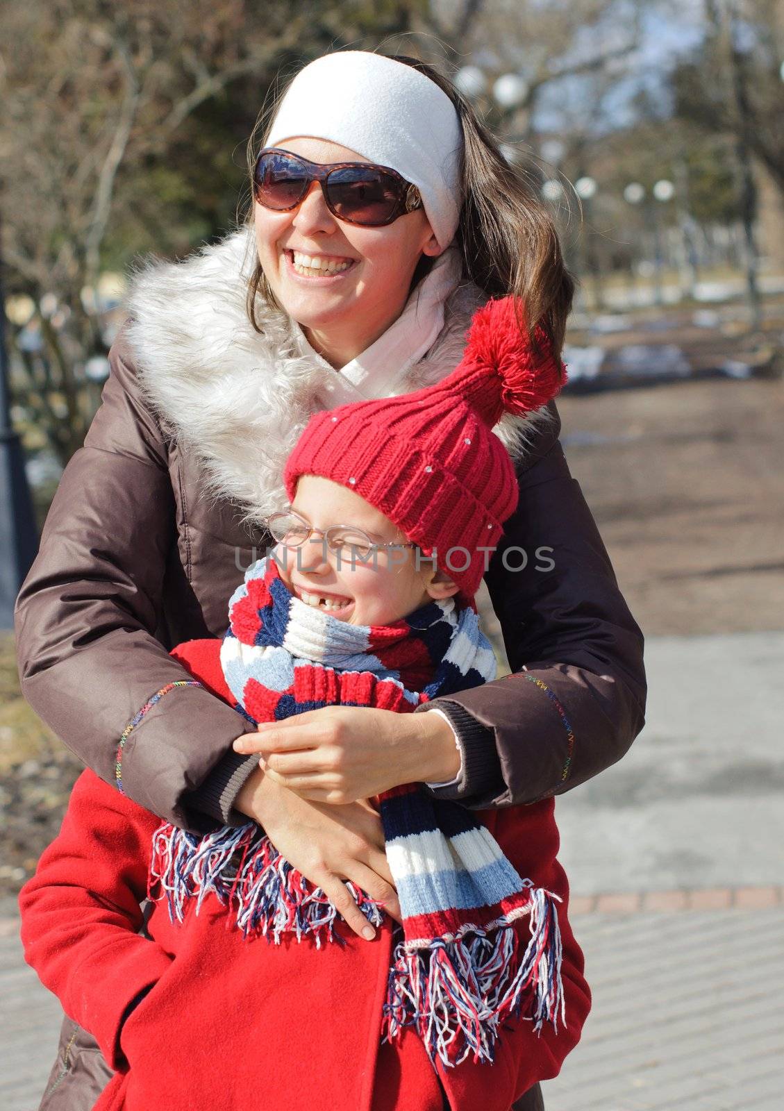 Happy mom with a daughter for a walk in the Spring Park