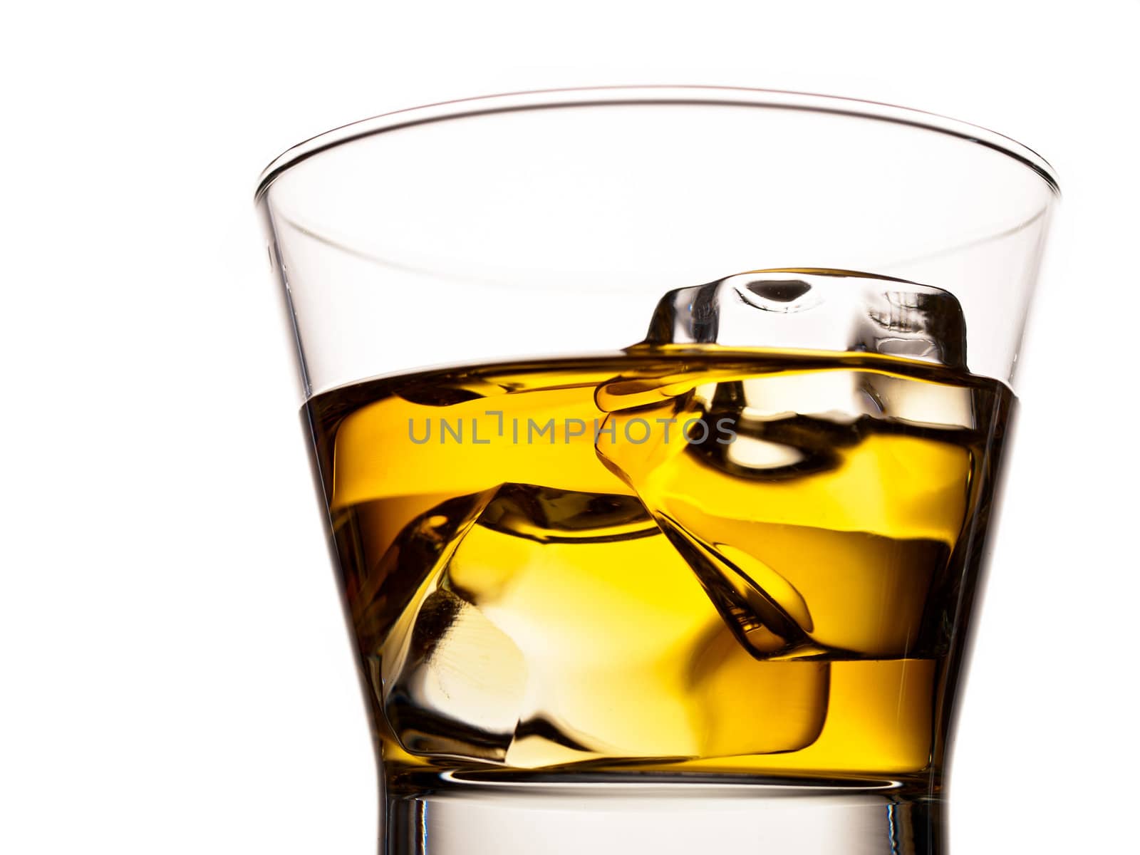 Whiskey on the rocks in an old fashion glass isolated on white