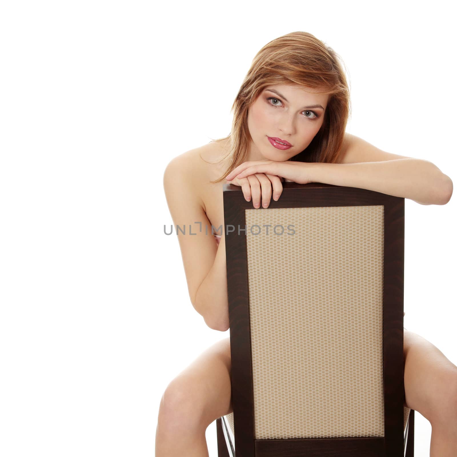 Teen girl in elegant make-up sitting on chair by BDS