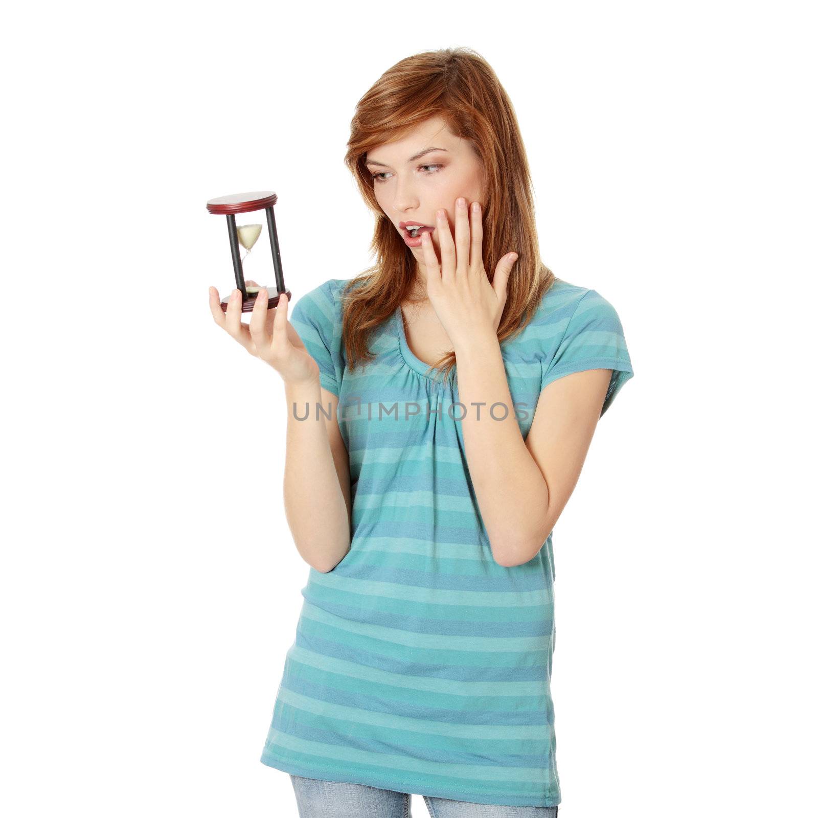 Teen woman holding hourglass, isolated on white