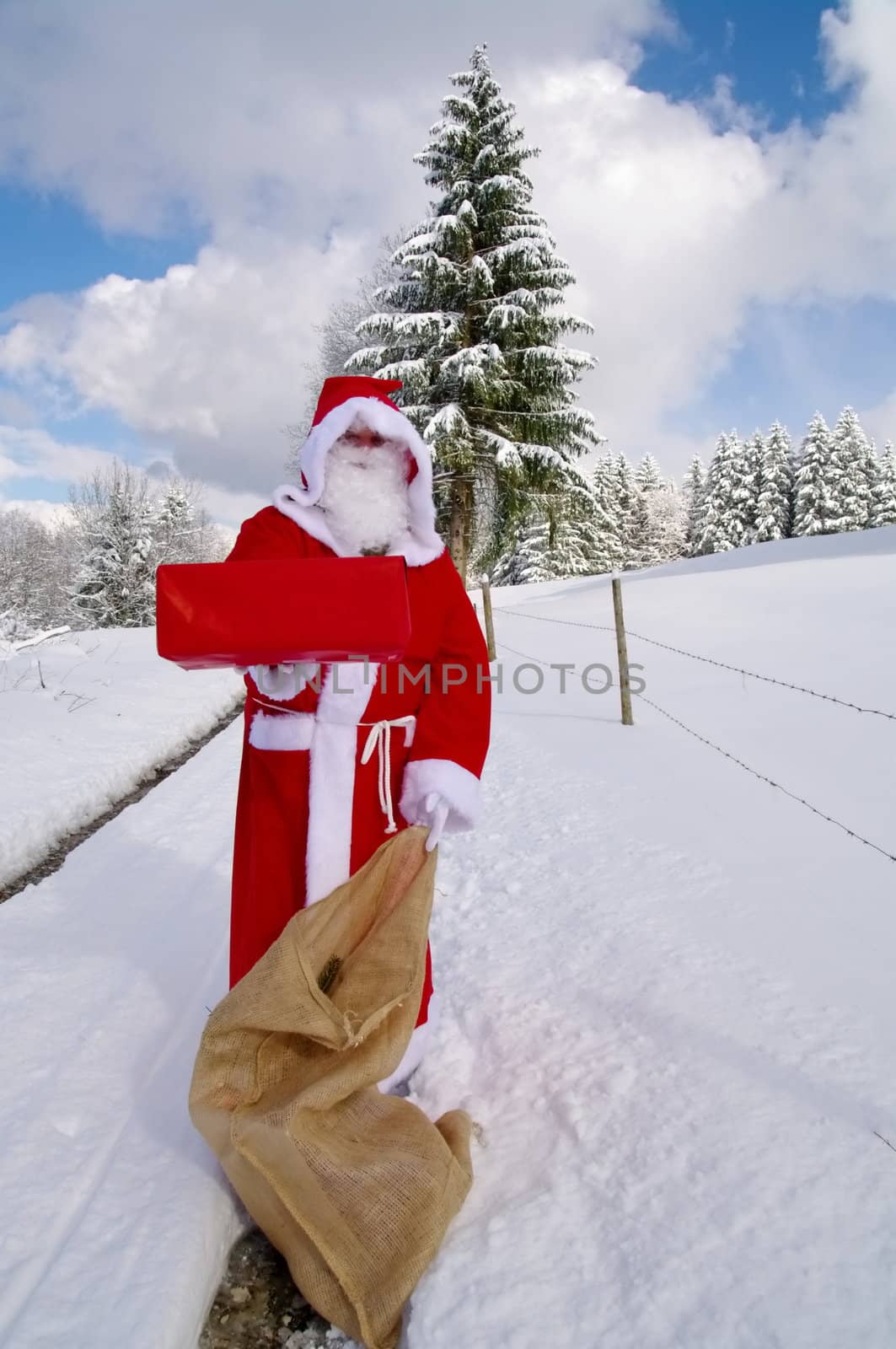 Santa Claus, Father Christmas holds red present