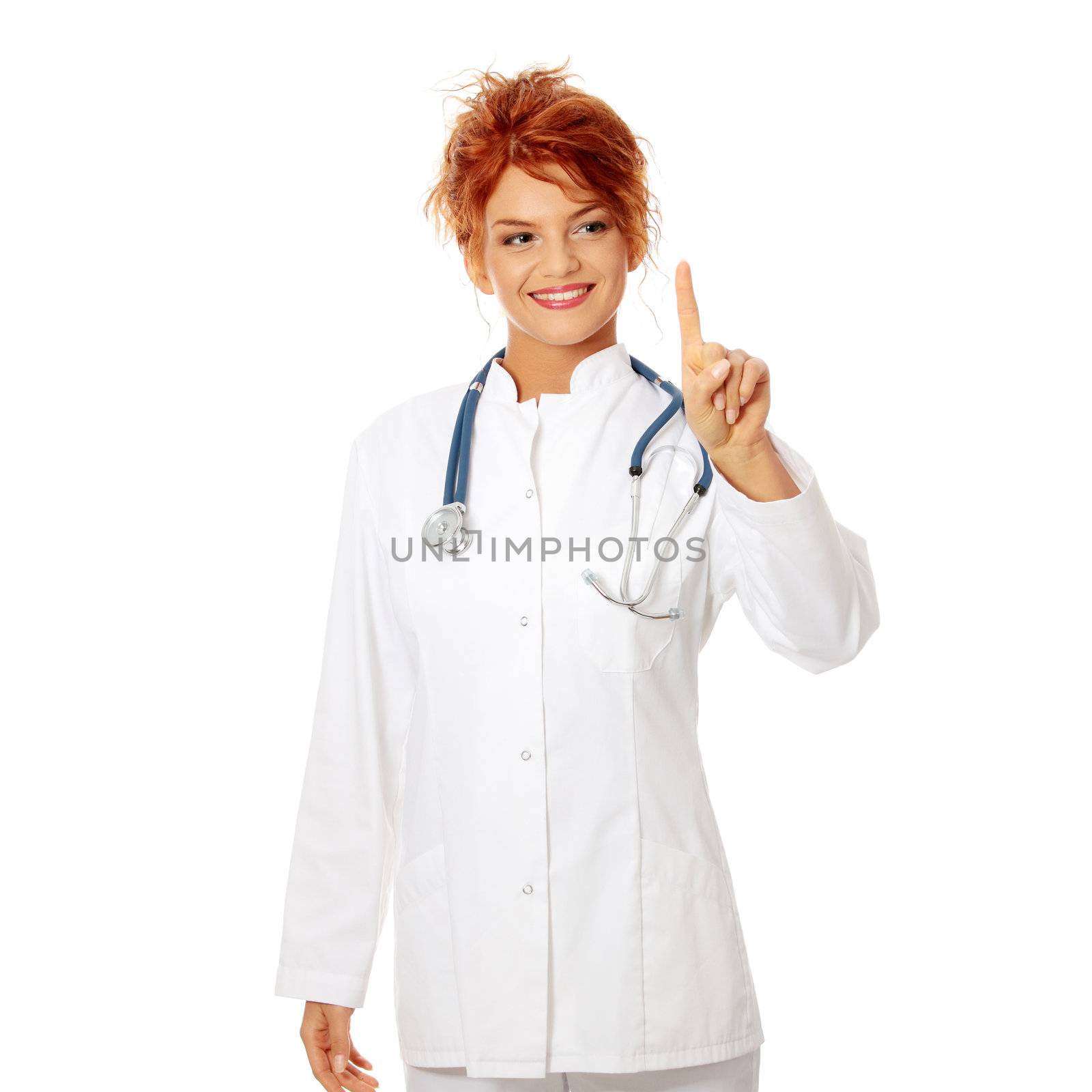 Smiling medical doctor or nurse making a choice with her finger on abstract screan. Isolated on white background