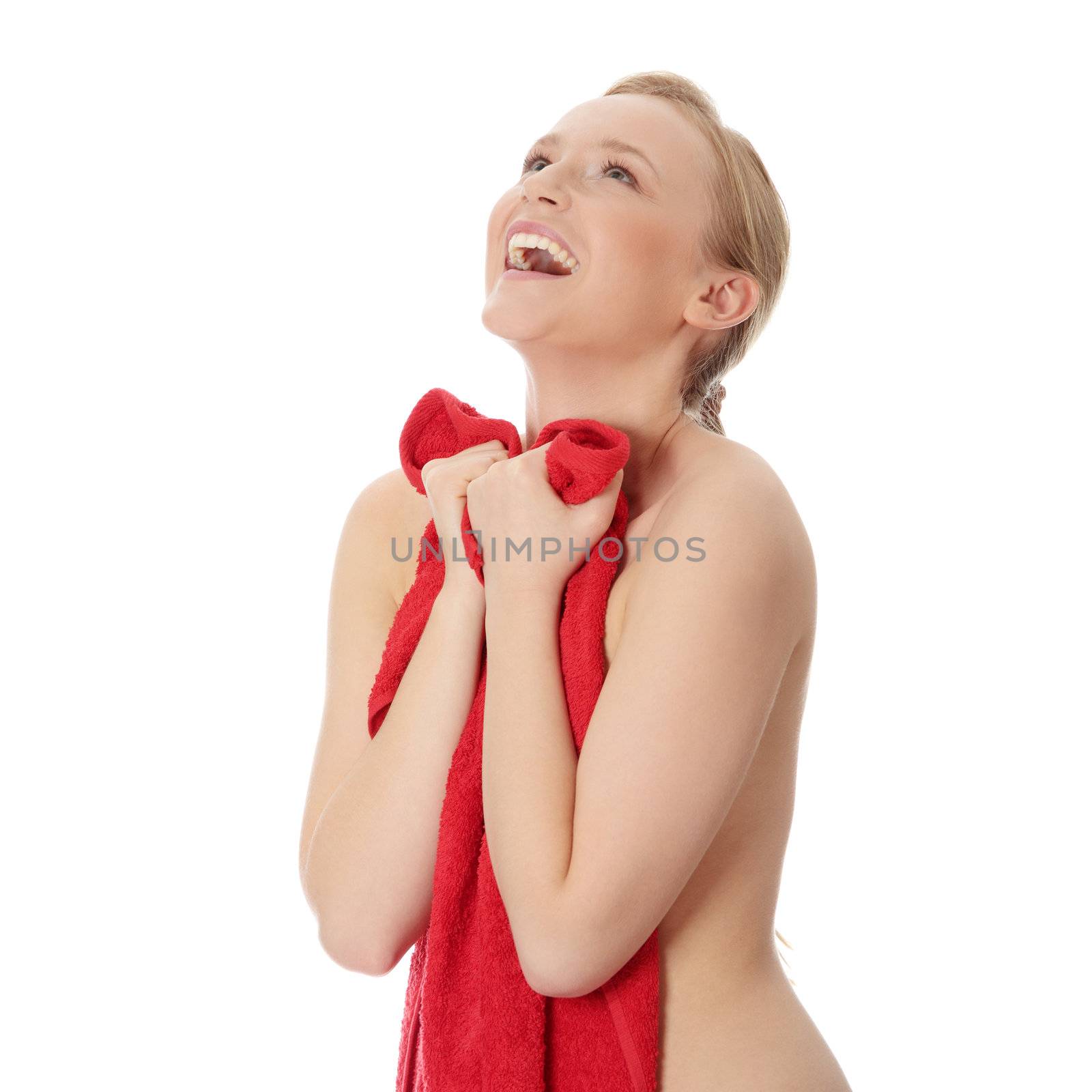 Attractive young nude woman covered by red towel, isolated on white