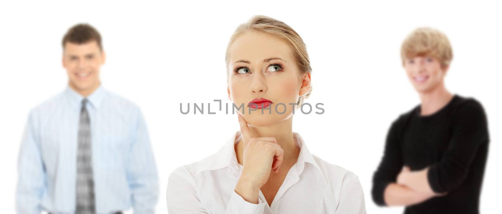 Thoughtful business woman looking right (making a choice) , isolated over a white background. Two young man in background