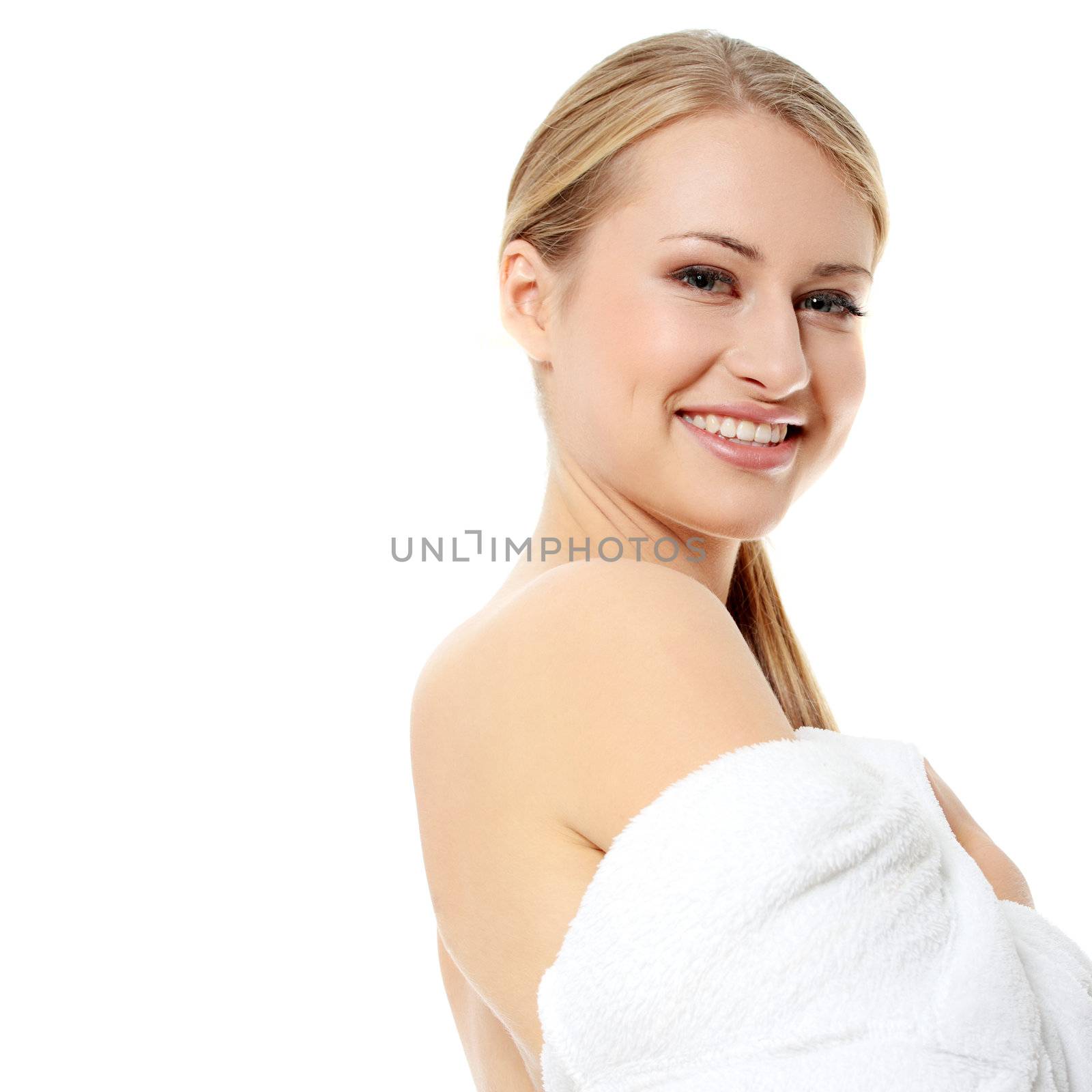 Young smiling blond teen woman wearing bathrobe , isolated on white