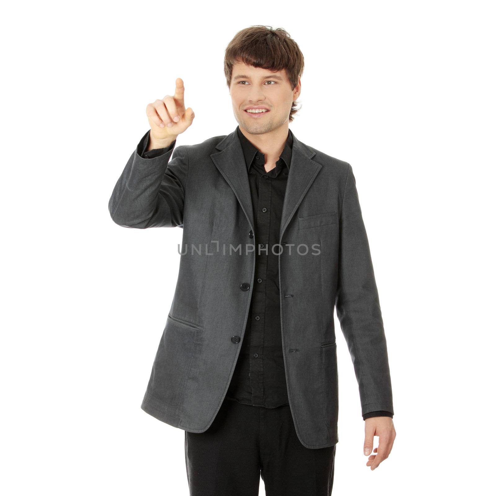 Handsome businessman pressing an abstract touchscreen button isolated on white