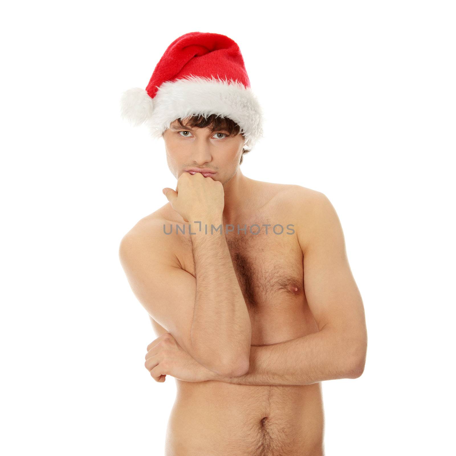 Young handsome man with Santa's cap standing naked. Isolated on white in studio.