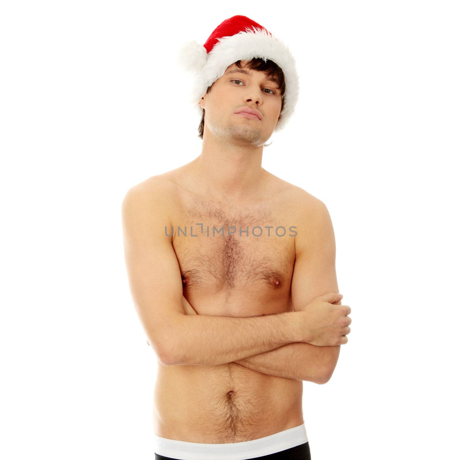 Young handsome man with Santa's cap. Isolated on white in studio.