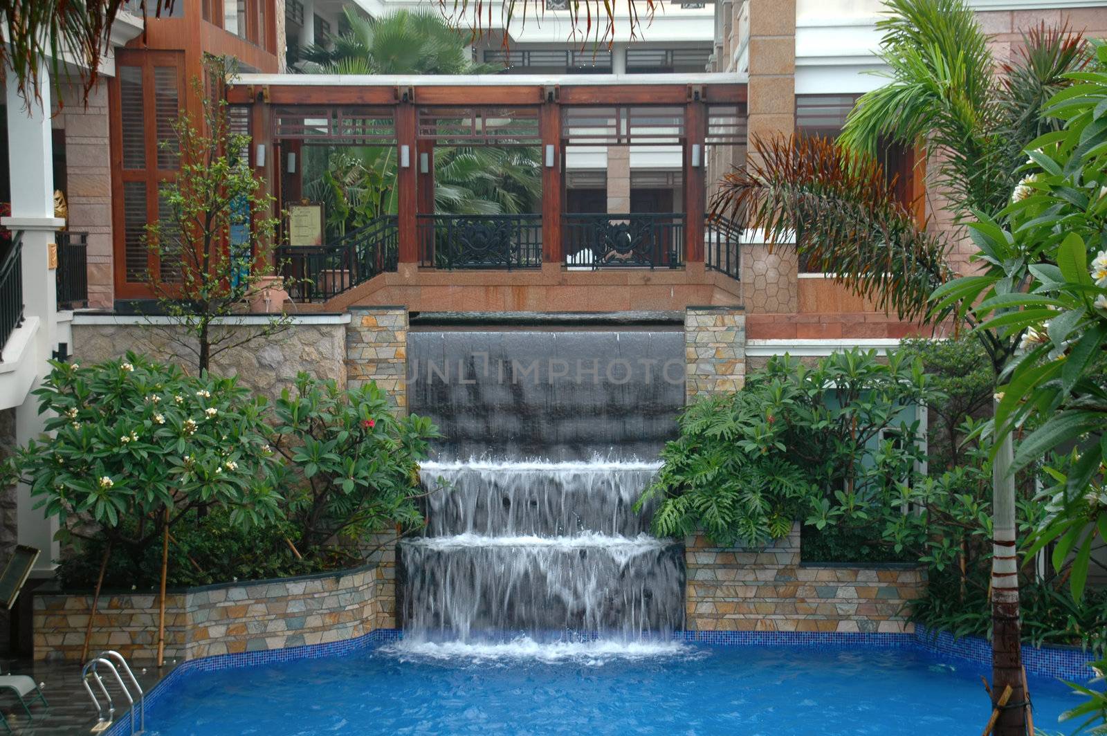The swimming pool and waterfall in hotel (resort)