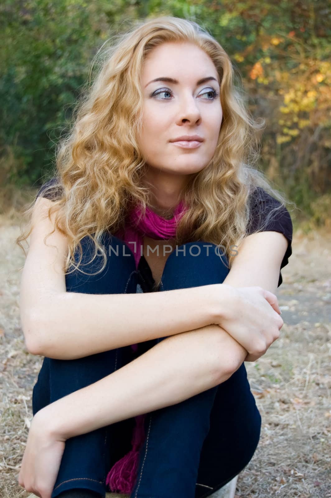 Thoughtful woman over fall background