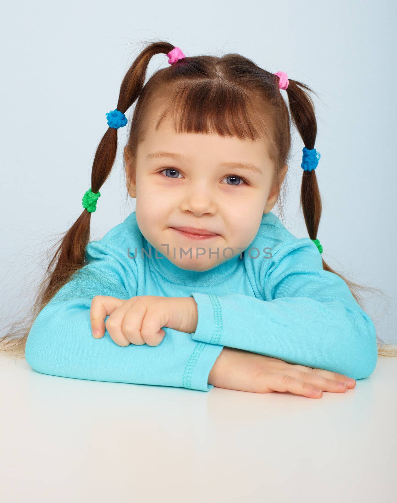 Portrait of a young girl sitting at the table