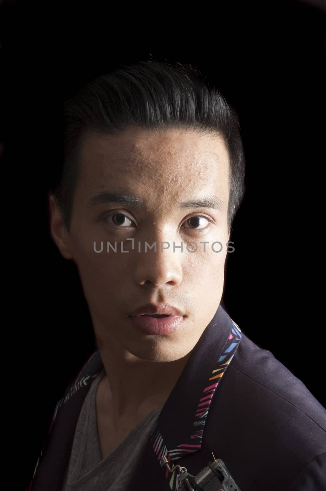closeup of a young asian man on a black background by jeffbanke