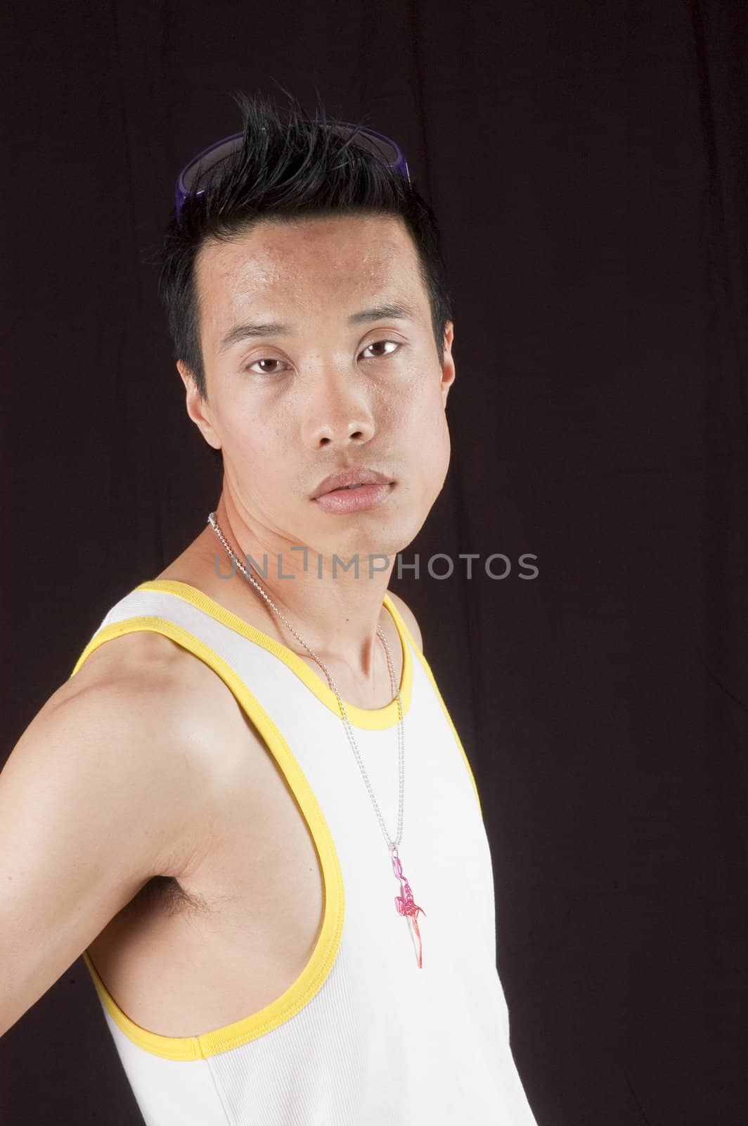 closeup of a young asian man on a black background