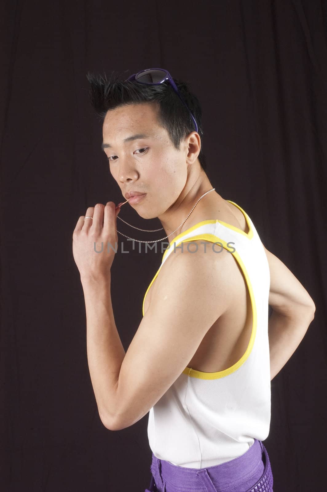 closeup of a young asian man on a black background