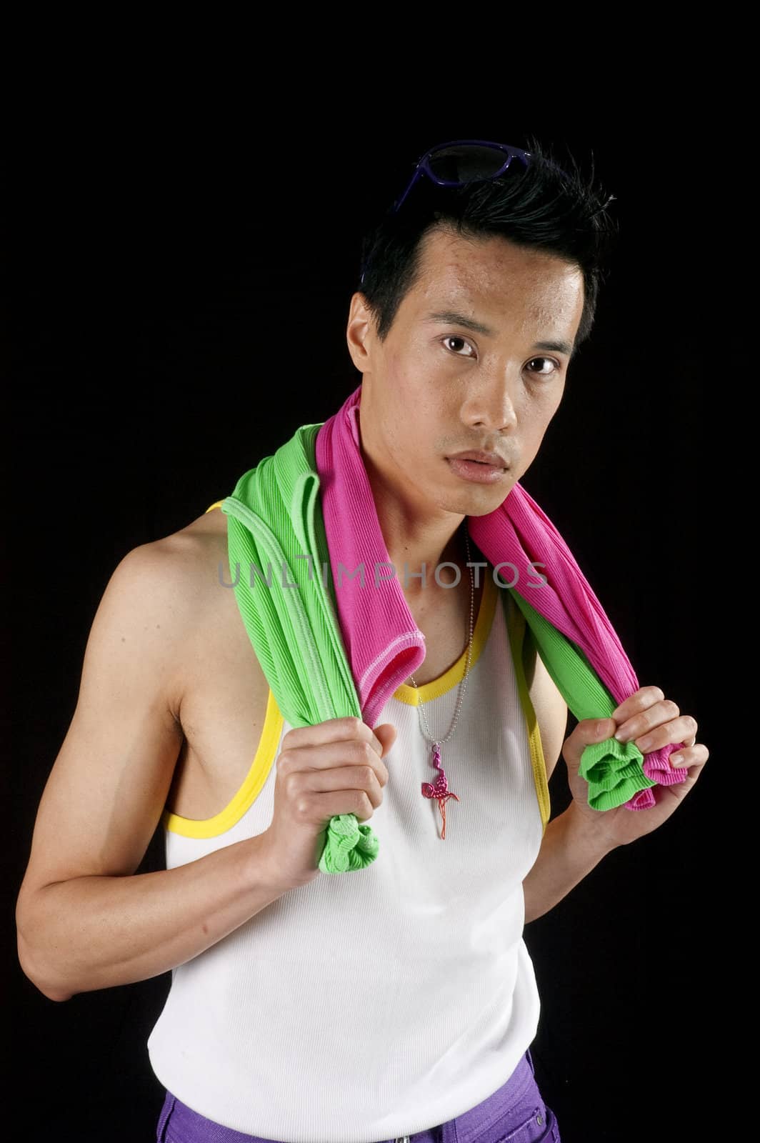 closeup of a young asian man on a black background with towel around neck