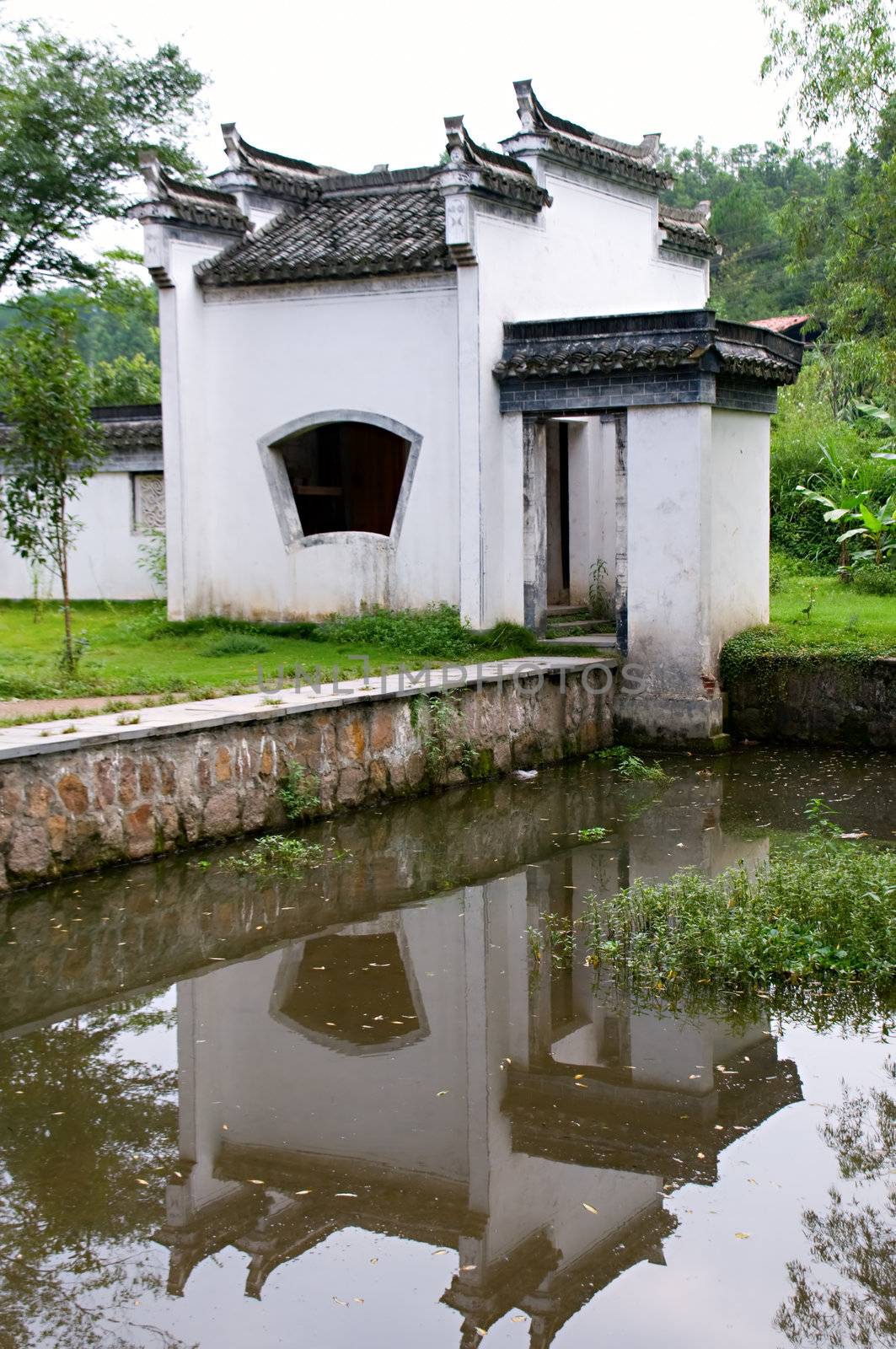 The Chinese architecture with reflection over lake in garden, jiangxi