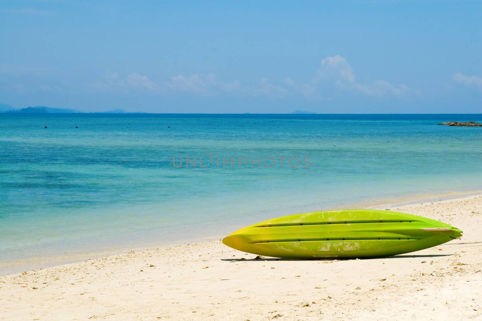 Beautiful beach with crystal clear blue water and surfboard
