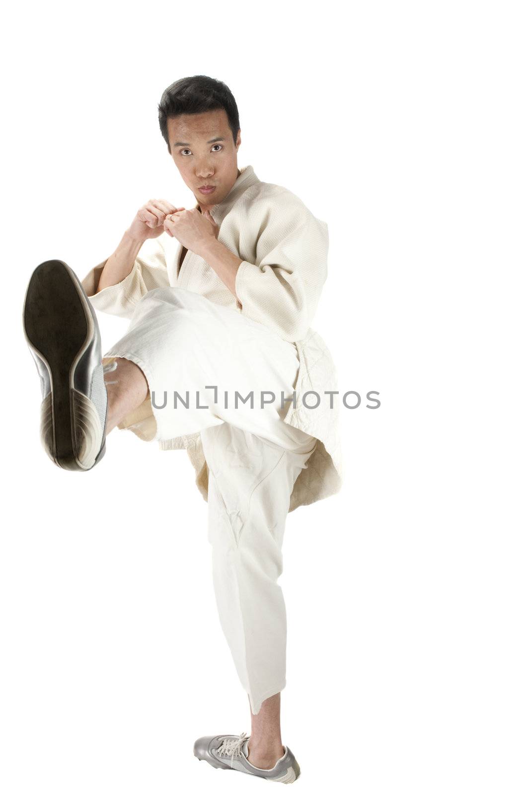 Young asian man practising karate kicks