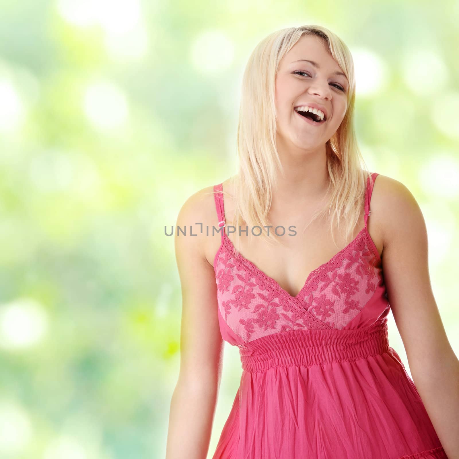 Young beautiful girl in short summer pink dress