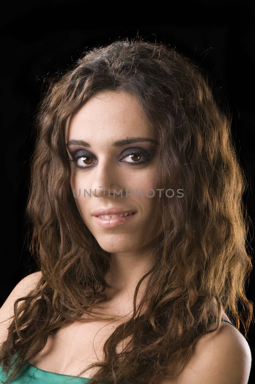 Young Greek woman in a green satin dress over a black background