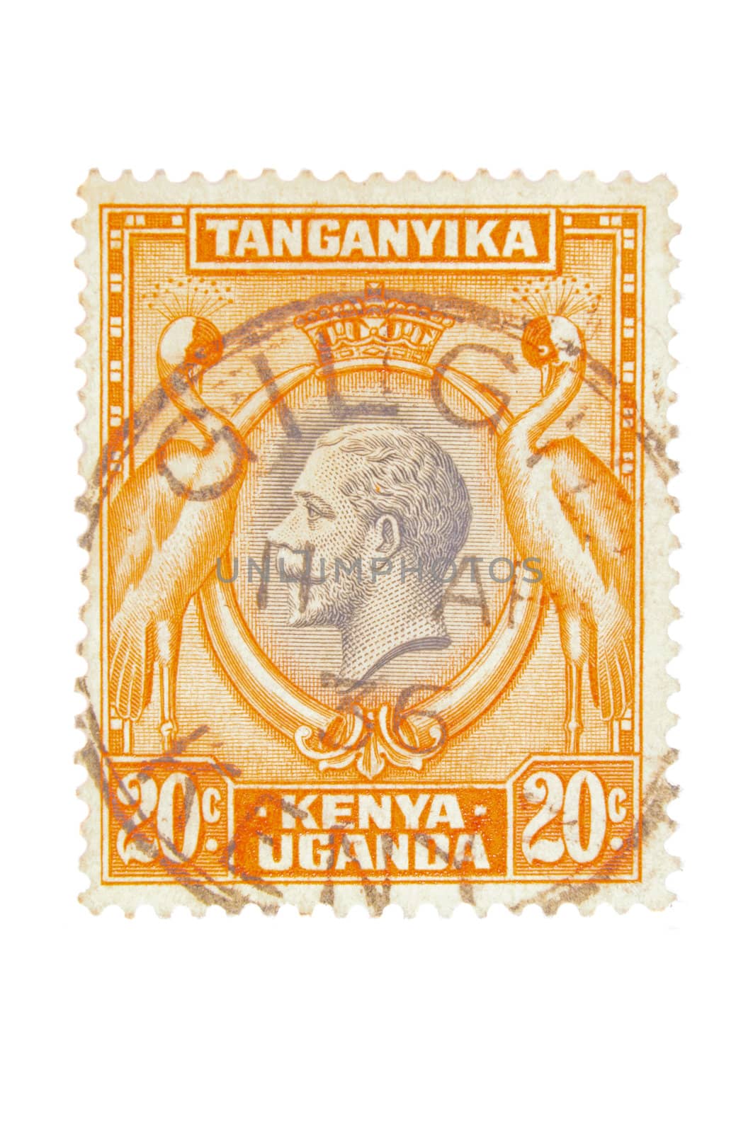 Kenya, Uganda & Tanganyika - Circa 1935 : A vintage British Colony postage stamp image of a pair of exotic birds either side of a portrait of King George and a value of 20 cents, series circa 1935